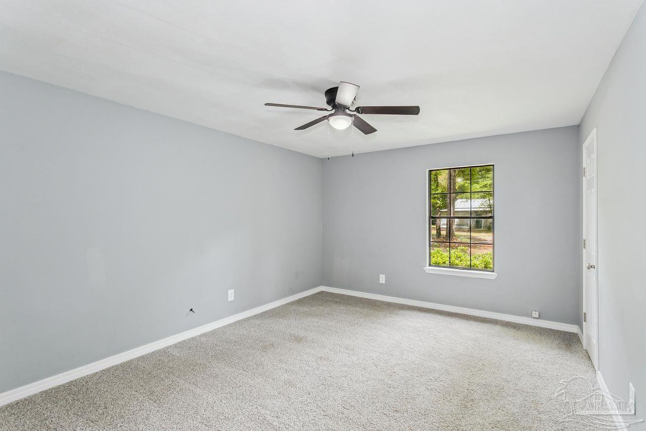 111 Cotton Creek Road McDavid, FL 32568 - Photo 19 of 37 wooden floor in an empty room with a window