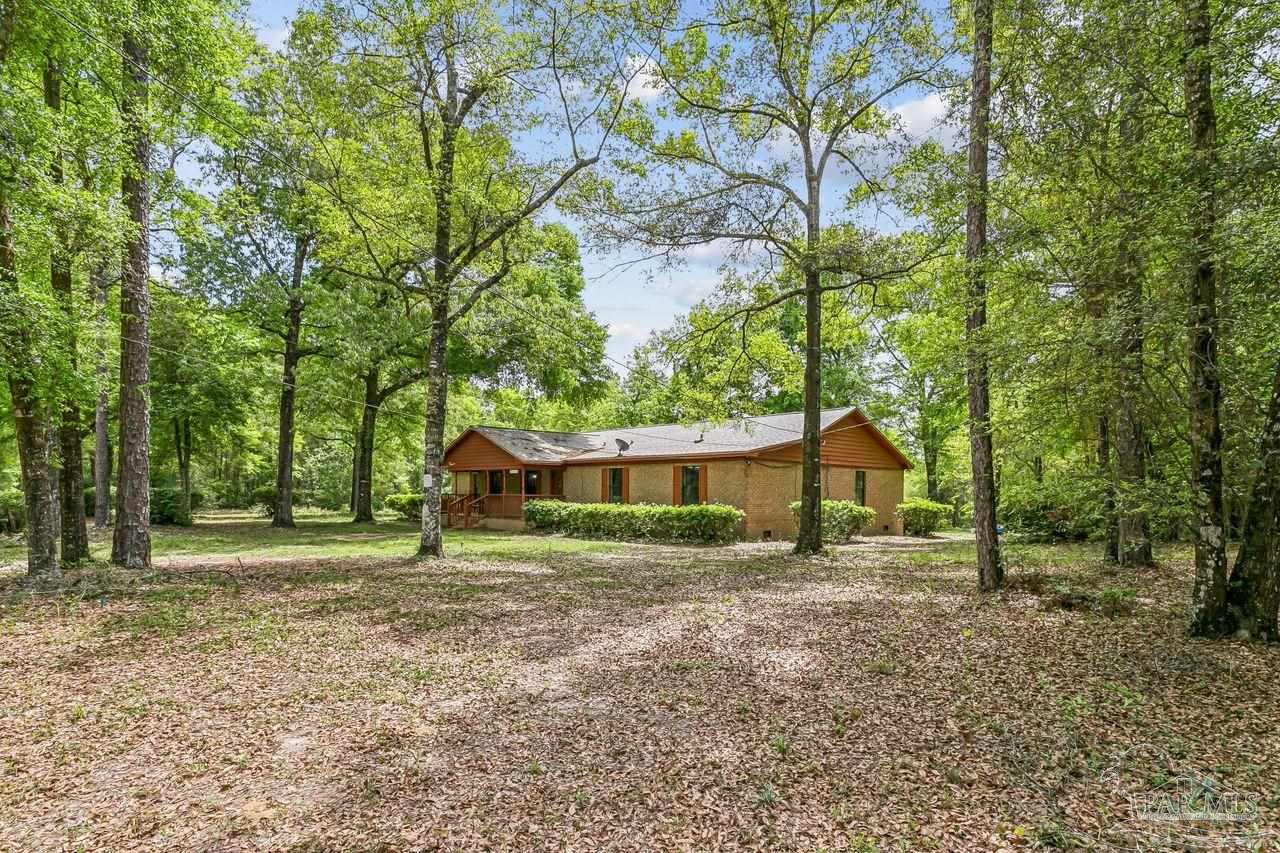111 Cotton Creek Road McDavid, FL 32568 - Photo 2 of 37 a house with trees in the background