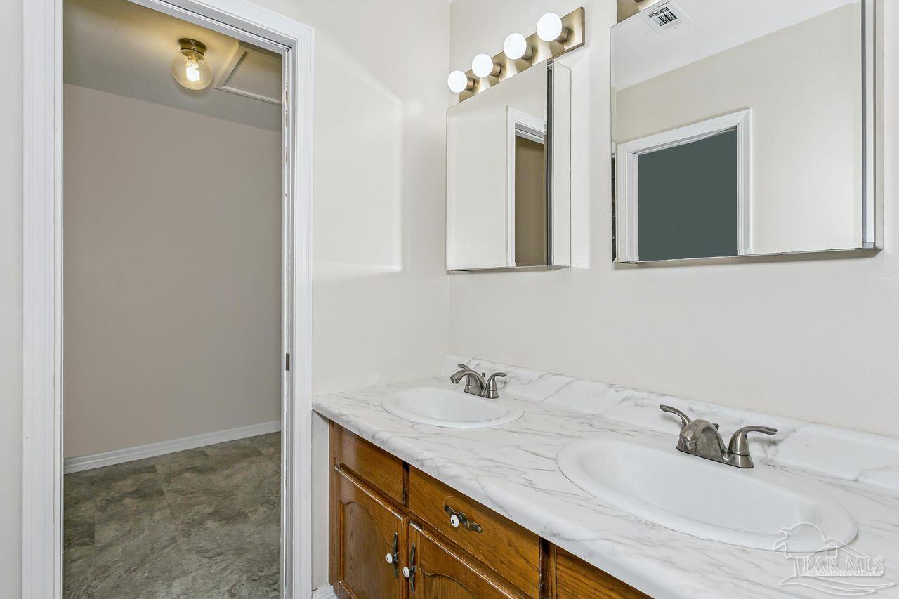111 Cotton Creek Road McDavid, FL 32568 - Photo 25 of 37 a bathroom with a sink and a mirror