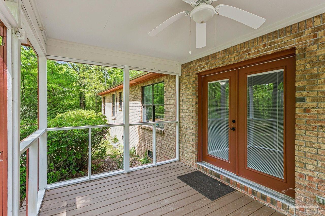 111 Cotton Creek Road McDavid, FL 32568 - Photo 27 of 37 a view of a room with windows and wooden floor