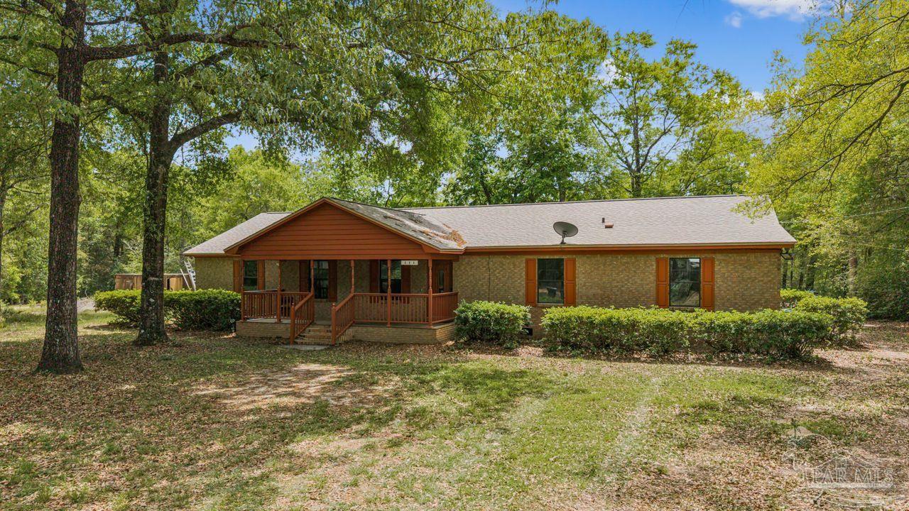 111 Cotton Creek Road McDavid, FL 32568 - Photo 37 of 37 a front view of a house with garden