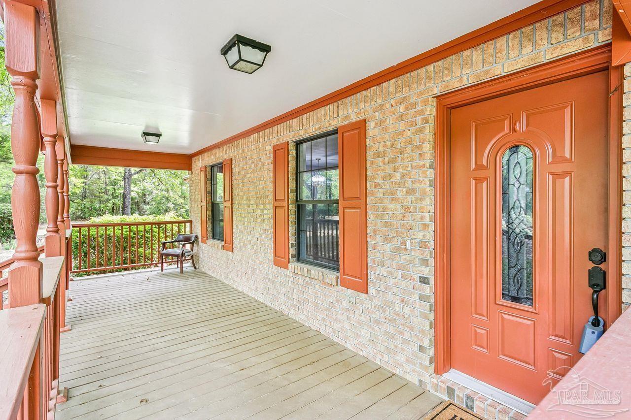 111 Cotton Creek Road McDavid, FL 32568 - Photo 4 of 37 a view of an entryway with wooden floor and door