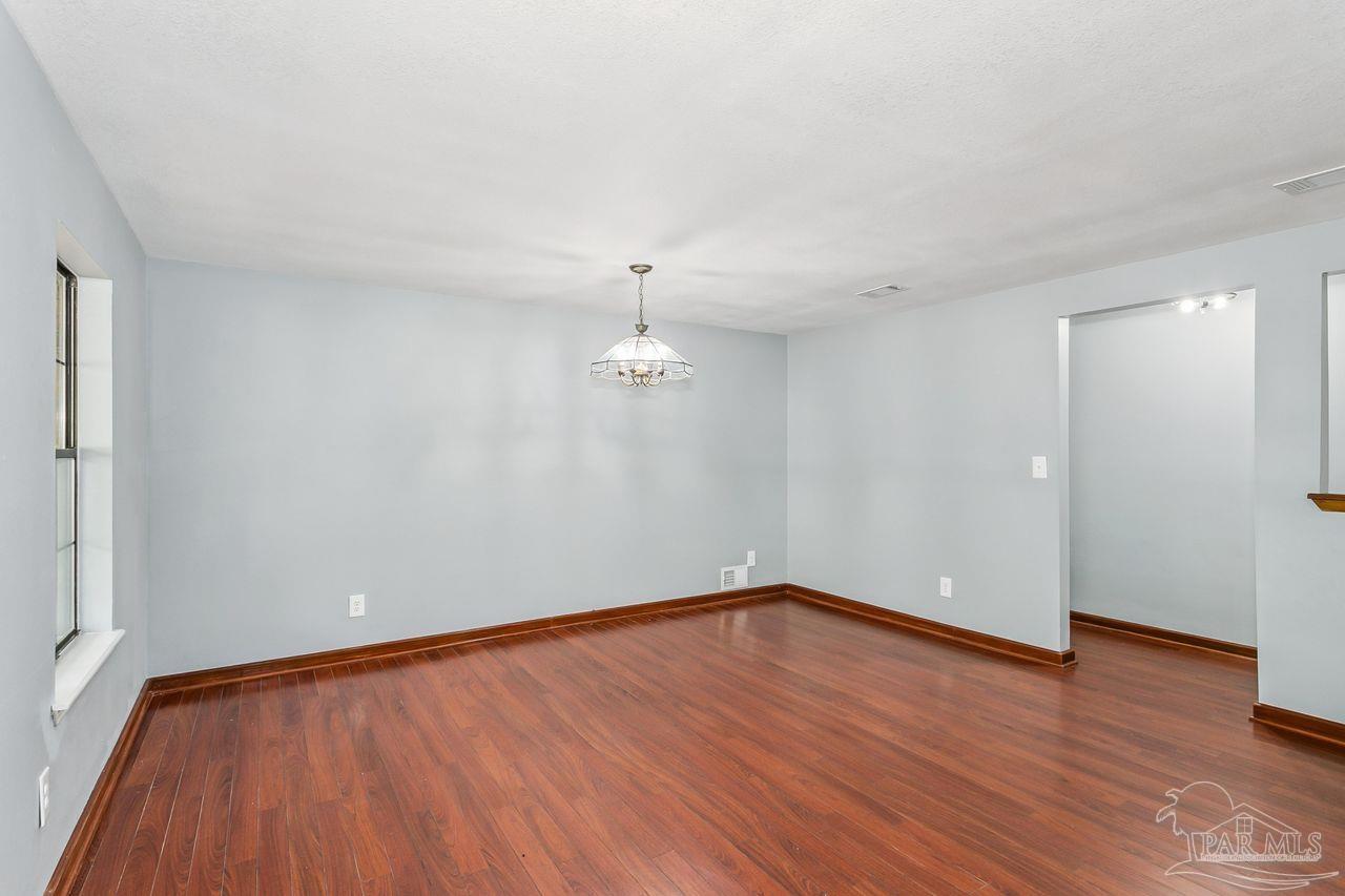 111 Cotton Creek Road McDavid, FL 32568 - Photo 9 of 37 a view of empty room with wooden floor and fan