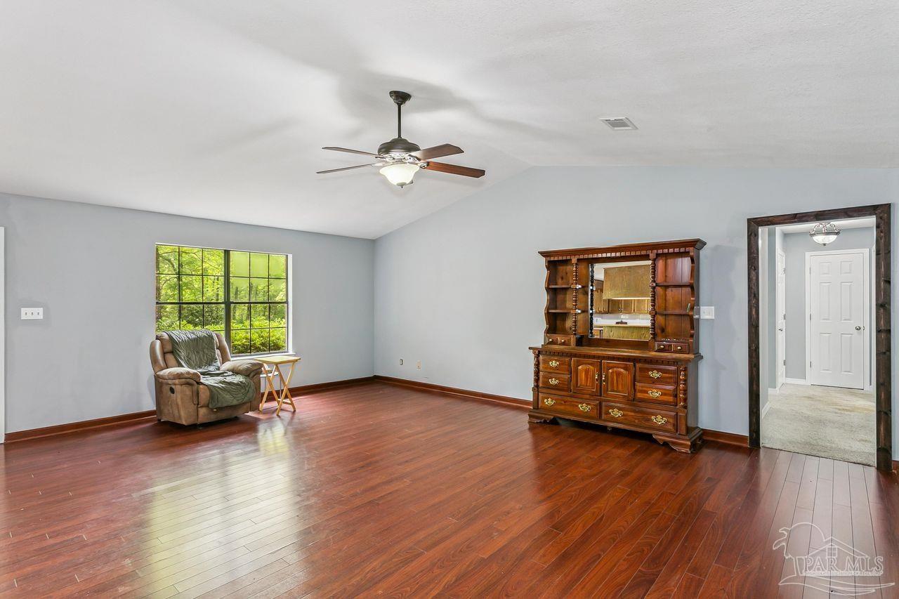 111 Cotton Creek Road McDavid, FL 32568 - Photo 10 of 37 a living room with furniture and wooden floor
