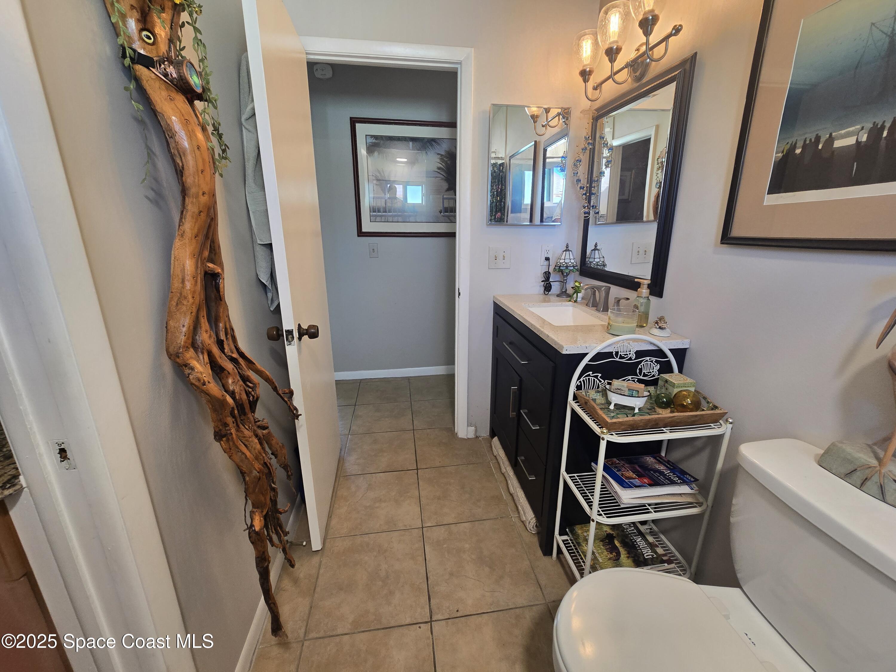 620 Ridge Club Drive, Unit 88 Melbourne, FL 32934 - Photo 11 of 18 a bathroom with a sink toilet and mirror
