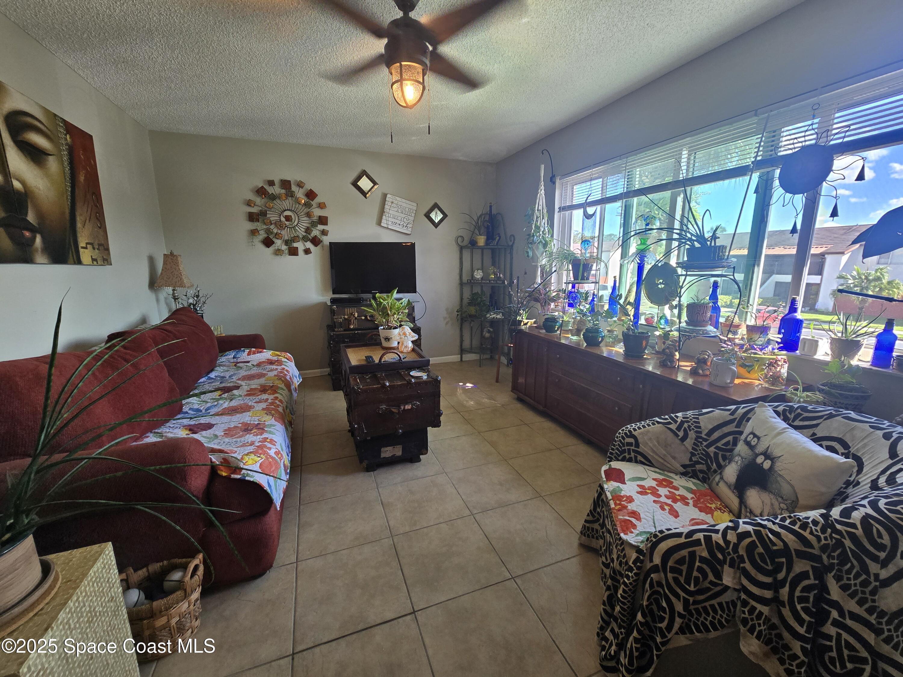 620 Ridge Club Drive, Unit 88 Melbourne, FL 32934 - Photo 7 of 18 a bedroom with furniture and a flat screen tv