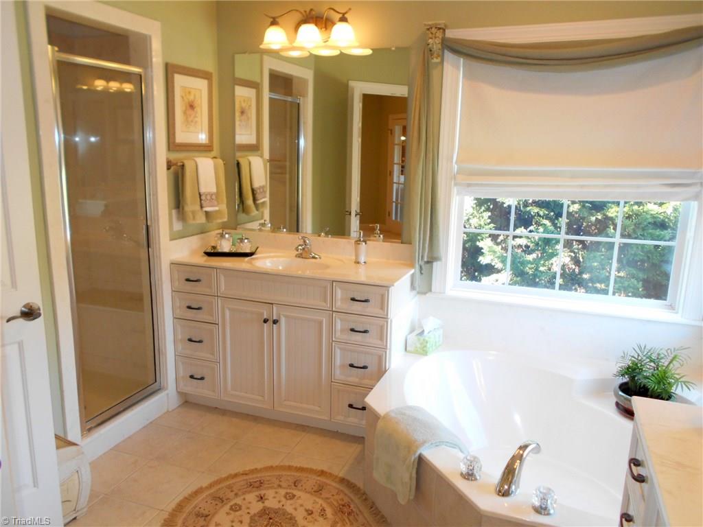 8643 Adkins Road Colfax, NC 27235 - Photo 15 of 30 Master bath features separate shower, dual vanity & garden tub.