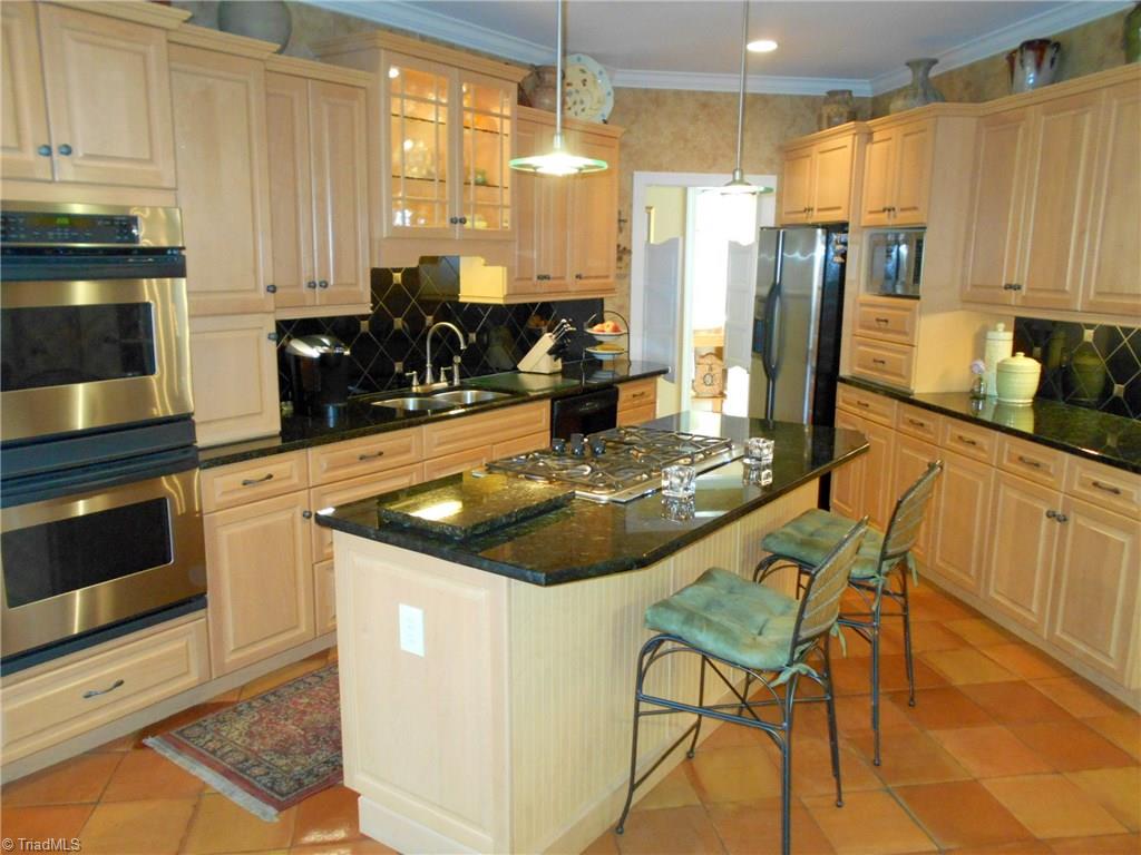 8643 Adkins Road Colfax, NC 27235 - Photo 9 of 30 Tile back splash and granite counters
