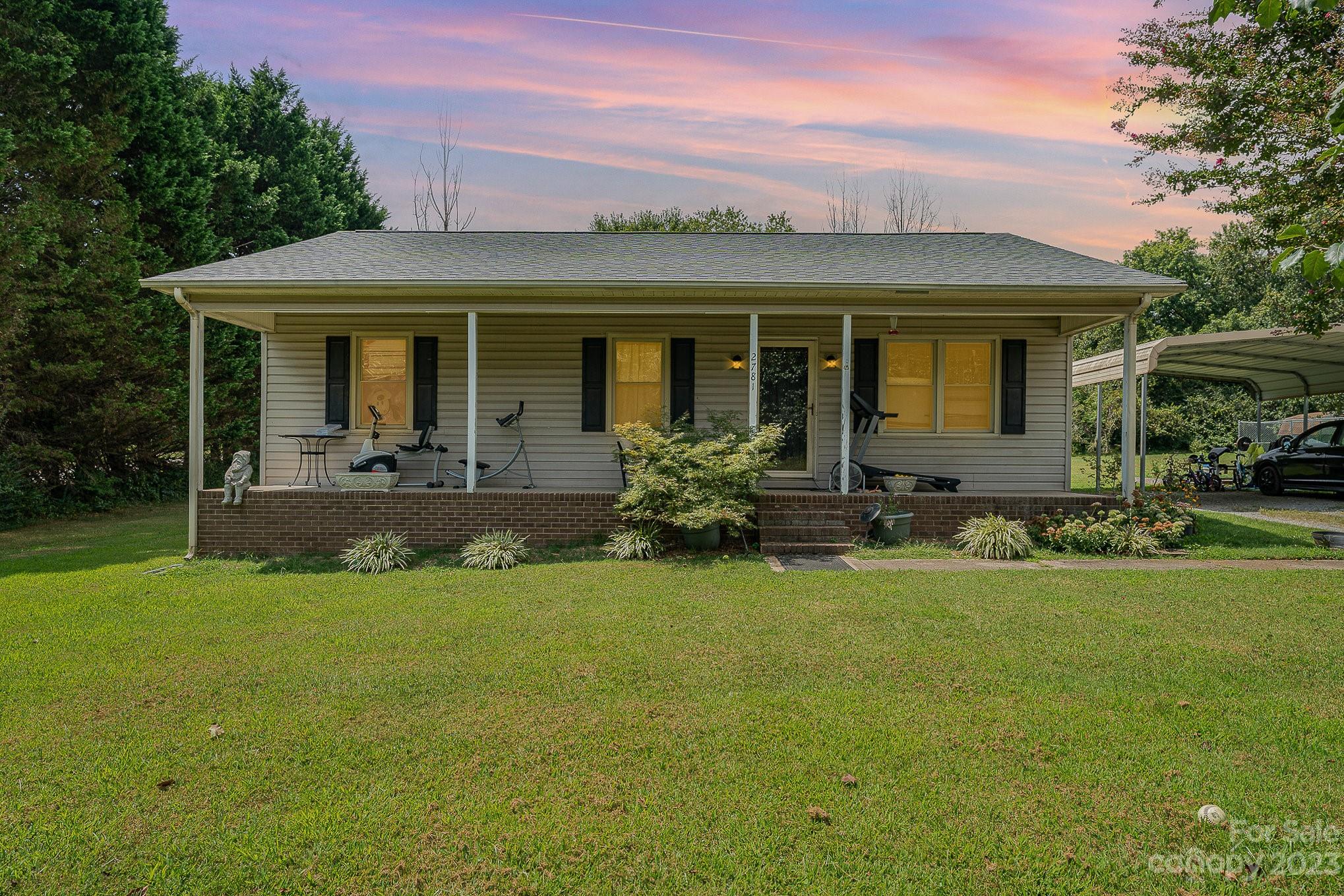 a front view of house with yard having outdoor seating