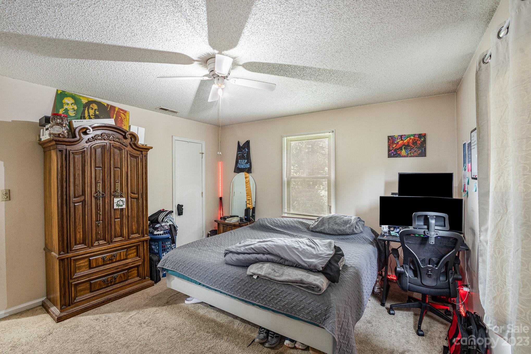 2781 St James Church Road Denver, NC 28037 - Photo 15 of 22 a bedroom with a bed and a chandelier