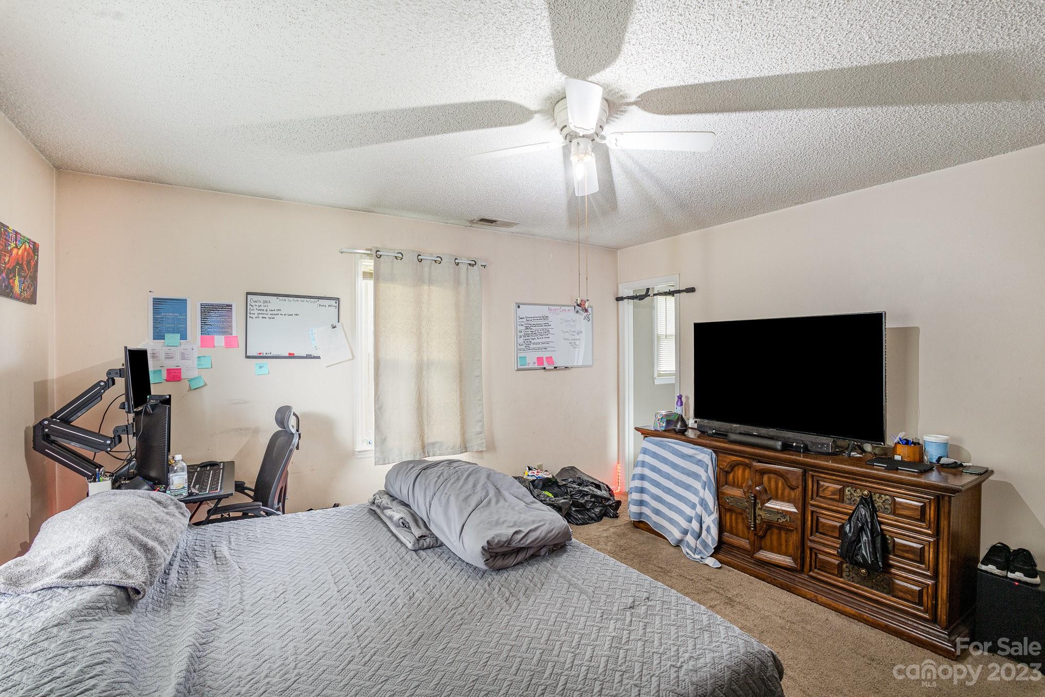2781 St James Church Road Denver, NC 28037 - Photo 17 of 22 a bedroom with furniture and a flat screen tv