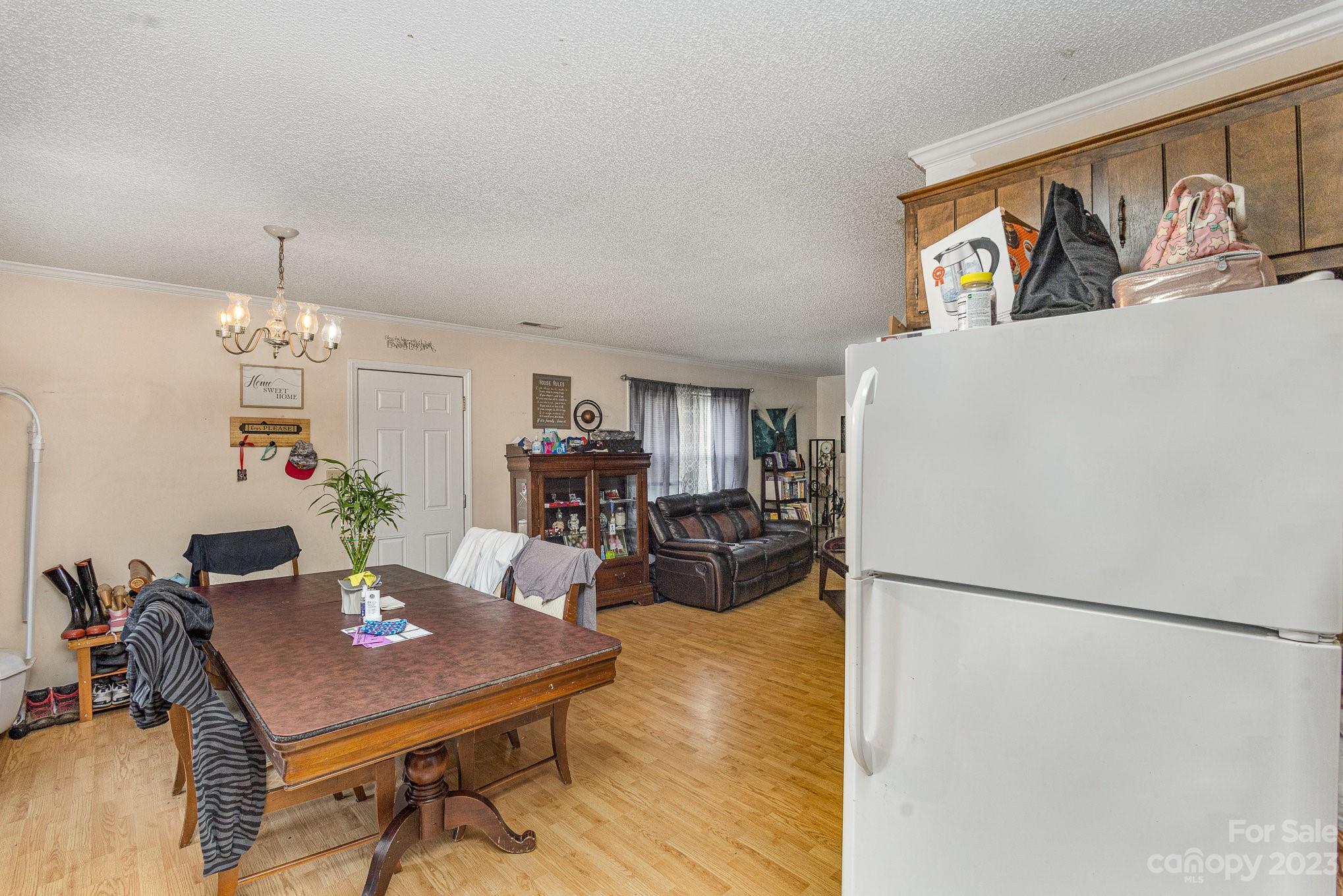 2781 St James Church Road Denver, NC 28037 - Photo 5 of 22 a view of a dining room with furniture a chandelier and wooden floor