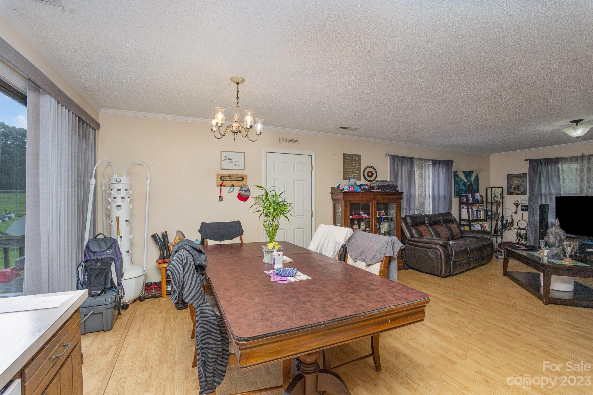 2781 St James Church Road Denver, NC 28037 - Photo 6 of 22 a view of a dining room with furniture and wooden floor