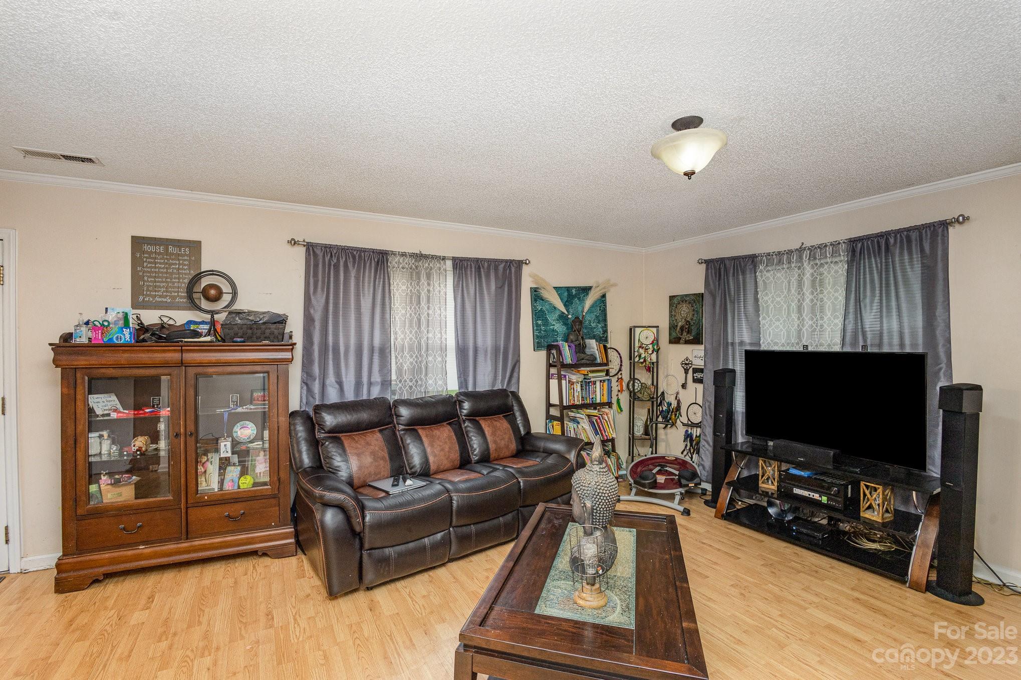 2781 St James Church Road Denver, NC 28037 - Photo 9 of 22 a living room with furniture and a flat screen tv