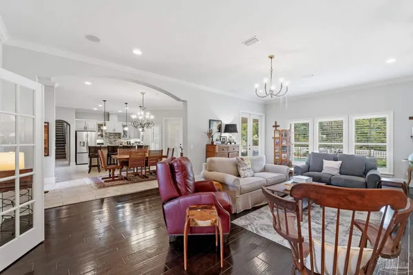 a kitchen with stainless steel appliances granite countertop a table chairs and a refrigerator