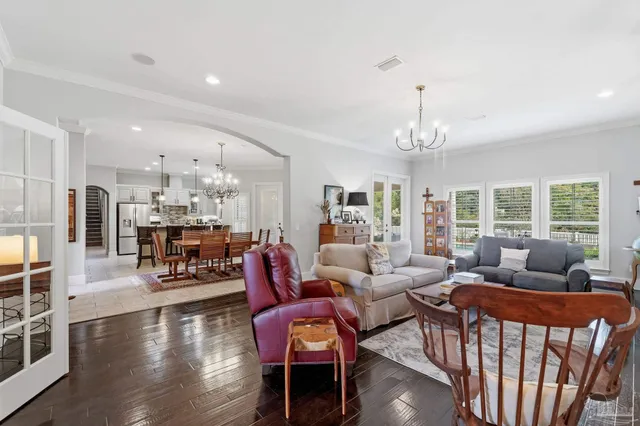 a kitchen with stainless steel appliances granite countertop a table chairs and a refrigerator