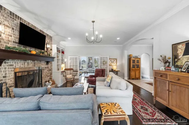 a bedroom with a large bed a flat tv screen and large window