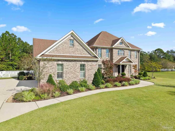 a front view of a house with a garden and plants