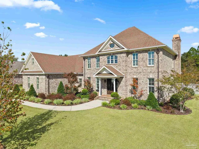 a front view of a house with a yard table and chairs