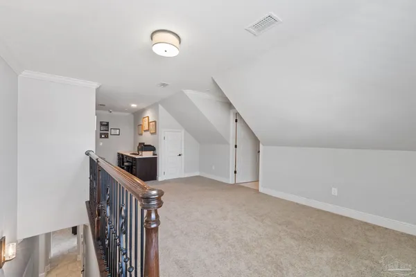 a view of a hallway with wooden floor and stairs