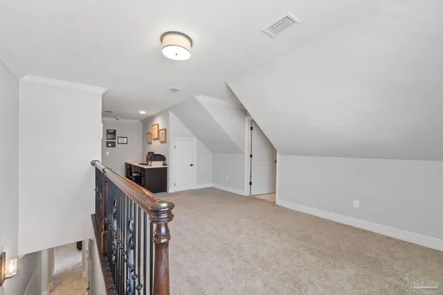 a view of a hallway with wooden floor and stairs