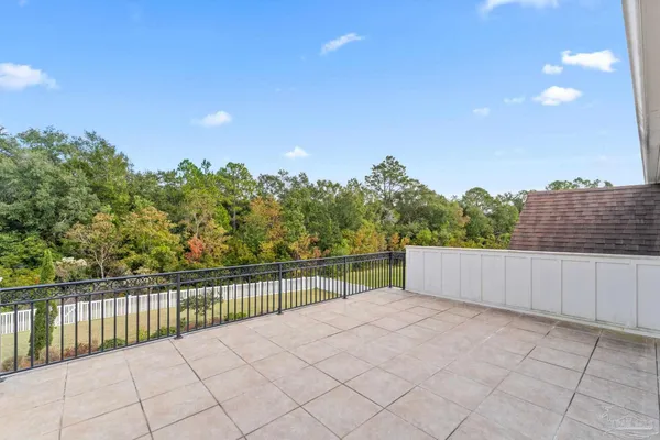 a view of a swimming pool with lawn chairs