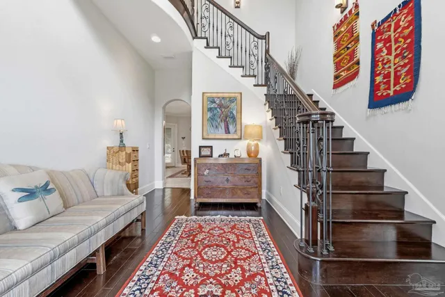 a view of a dining room and livingroom with furniture wooden floor a chandelier