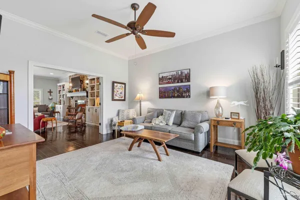 a dining room with furniture a chandelier and wooden floor