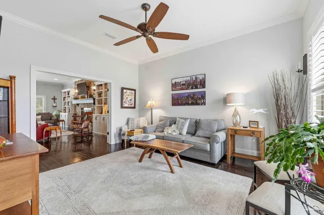 a dining room with furniture a chandelier and wooden floor