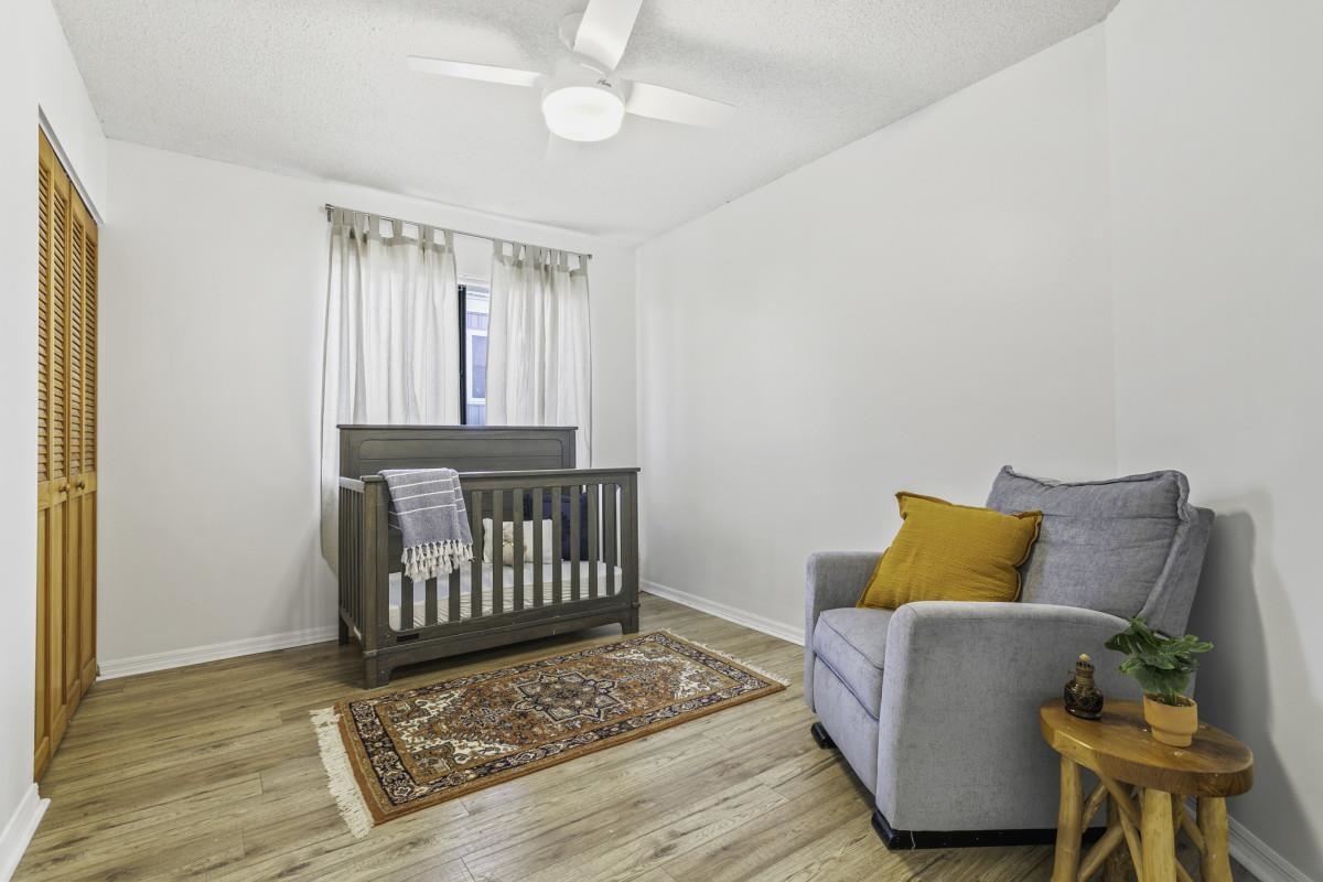 5484 5th Street St. Augustine, FL 32080 - Photo 12 of 37 a bedroom with a bed and wooden floor