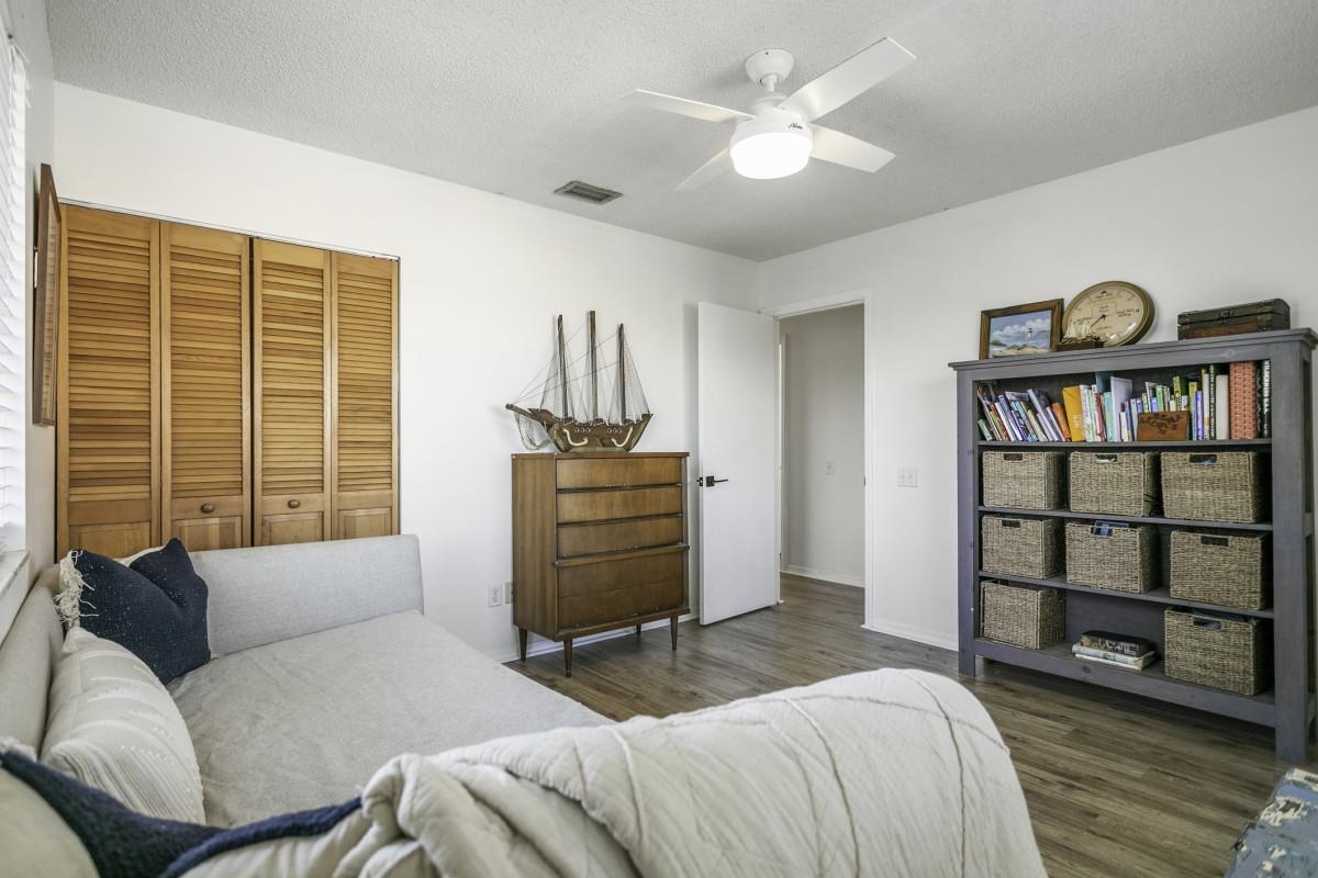 5484 5th Street St. Augustine, FL 32080 - Photo 13 of 37 a bedroom with a bed a dresser and a book shelf