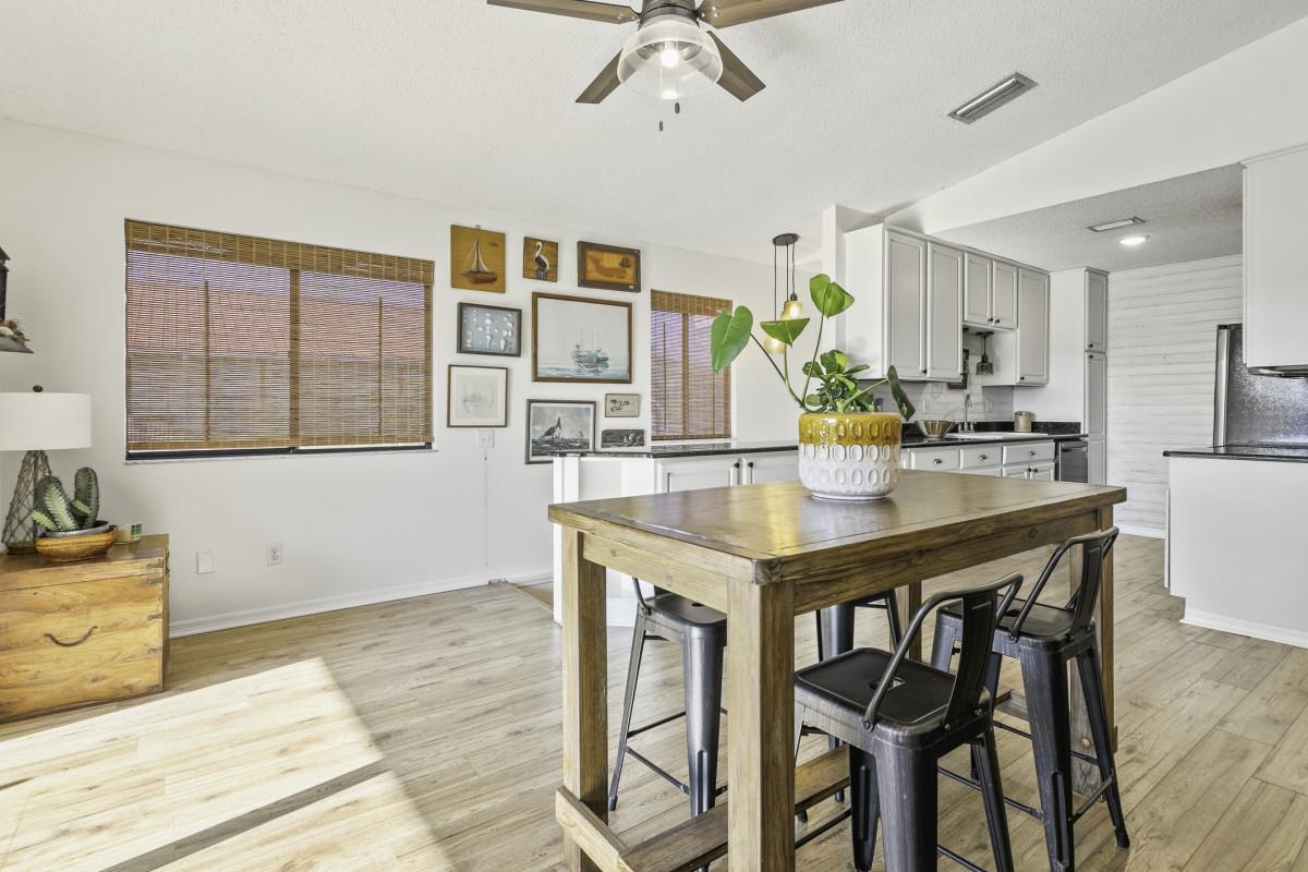 5484 5th Street St. Augustine, FL 32080 - Photo 20 of 37 a kitchen with a table chairs sink and cabinets