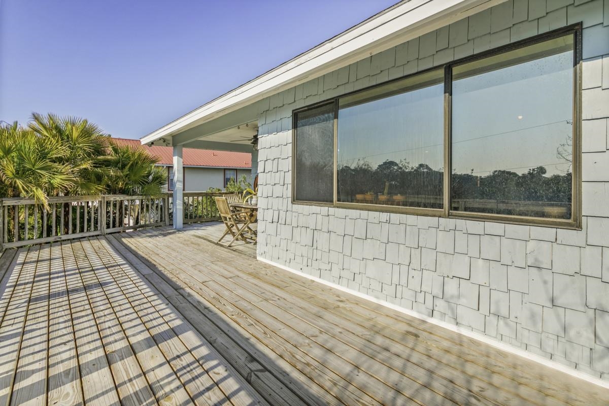 5484 5th Street St. Augustine, FL 32080 - Photo 26 of 37 a view of a porch with wooden floor and bench