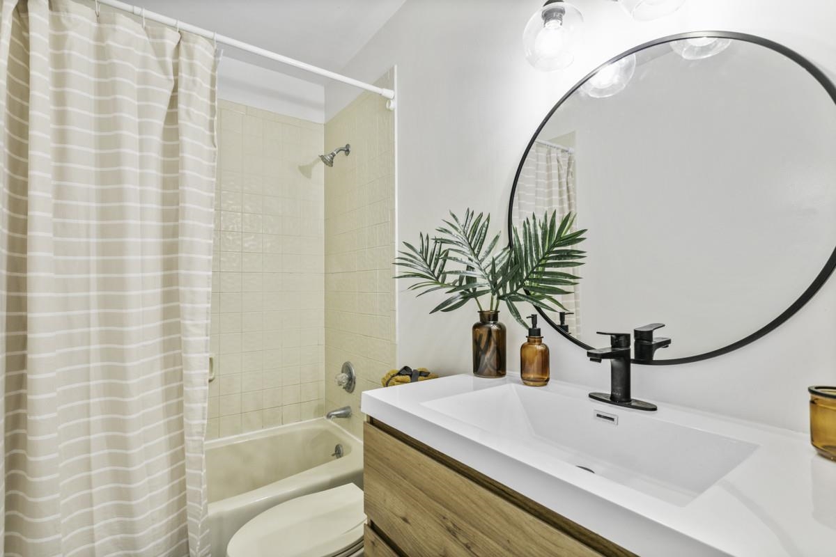 5484 5th Street St. Augustine, FL 32080 - Photo 30 of 37 a bathroom with a sink and a mirror