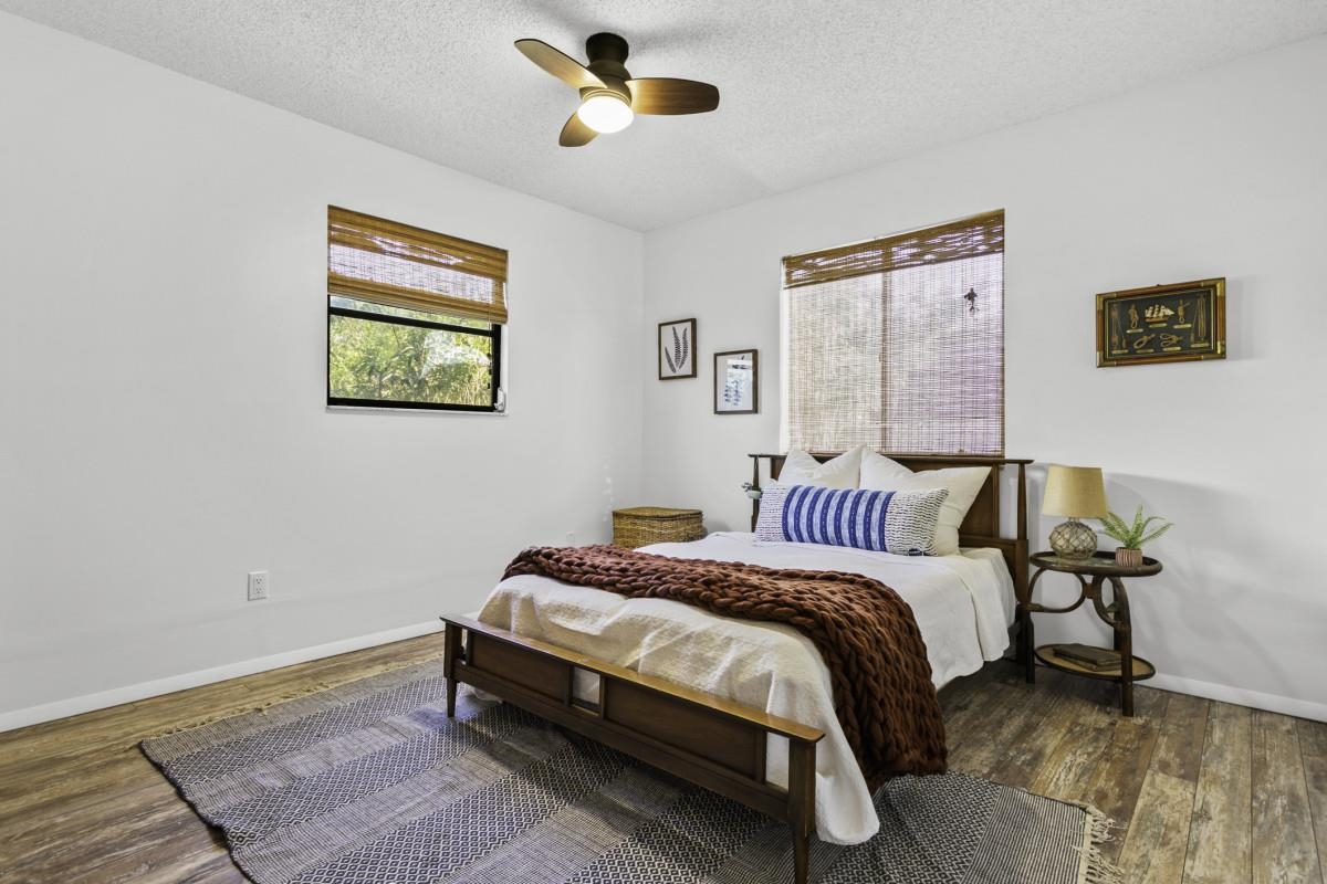 5484 5th Street St. Augustine, FL 32080 - Photo 34 of 37 a bedroom with a bed and painting on the wall