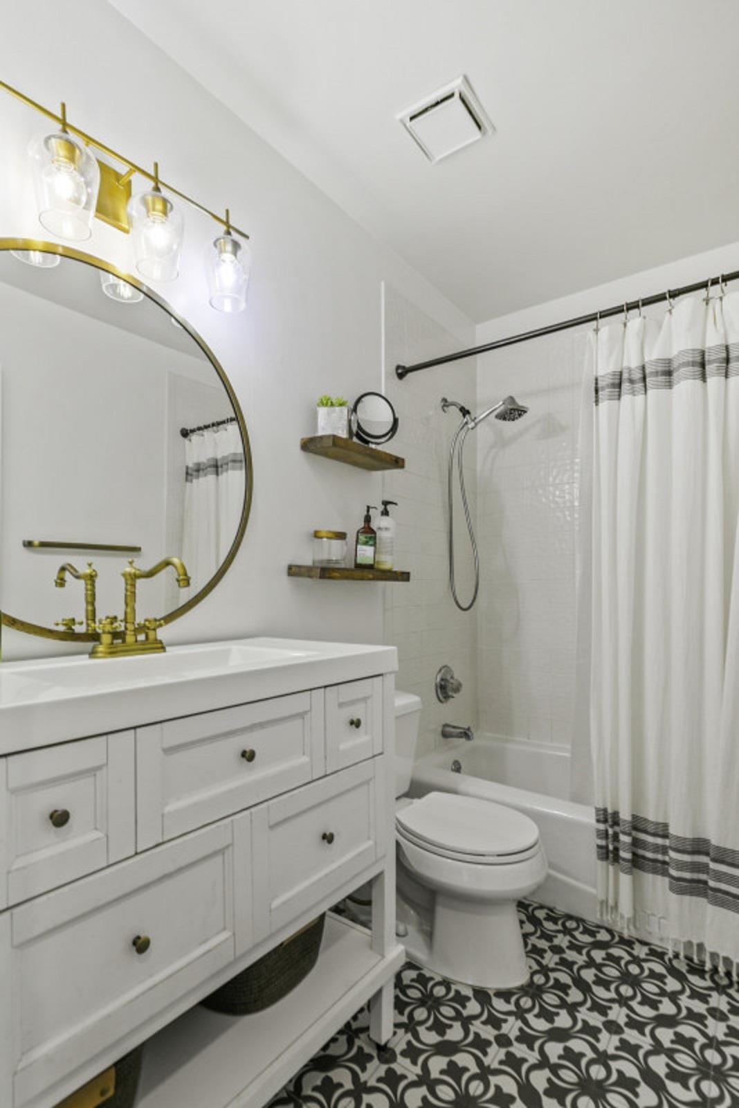 5484 5th Street St. Augustine, FL 32080 - Photo 8 of 37 a bathroom with a granite countertop sink a toilet and a mirror