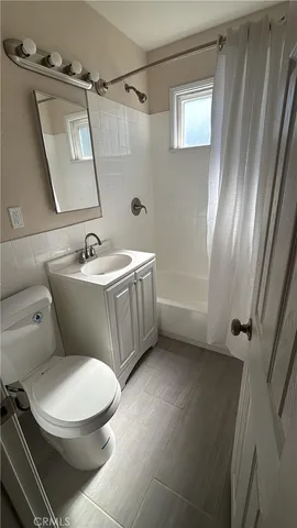 a white toilet sitting next to a bathroom sink