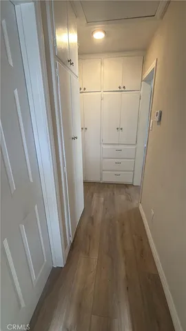 a view of hallway with wooden floor