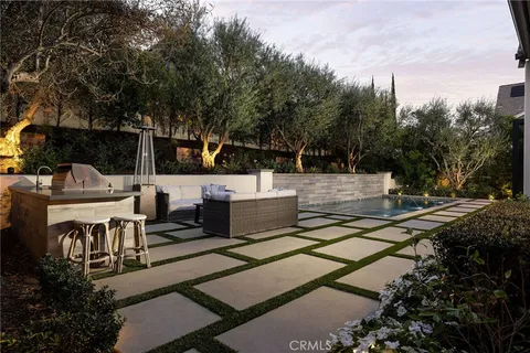 a view of a patio with chairs and potted plants