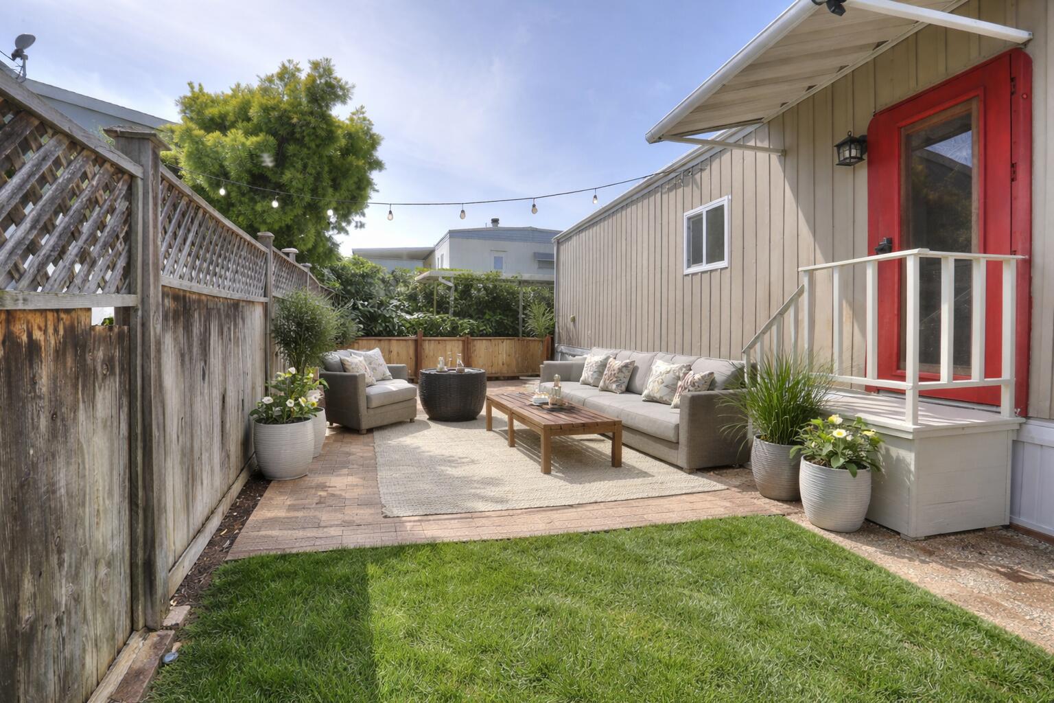 30 Winchester Canyon Road, Unit SPC 50 Goleta, CA 93117 - Photo 21 of 30 a view of a patio with couches chairs potted plants and wooden fence