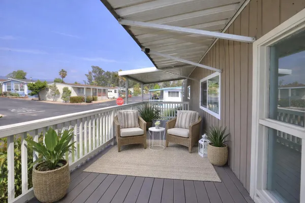 a view of a balcony with wooden floor