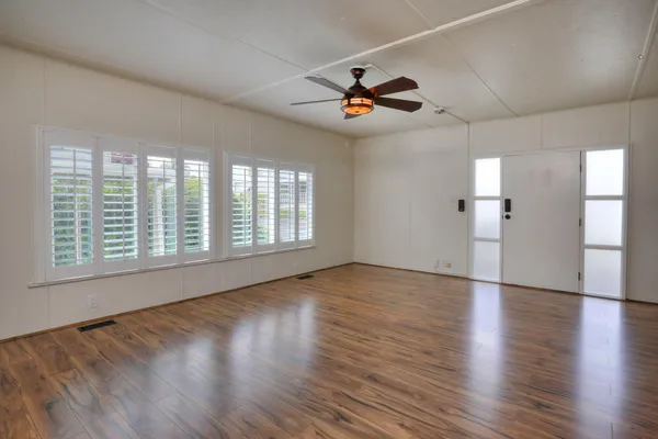 a kitchen with a sink cabinets and wooden floor