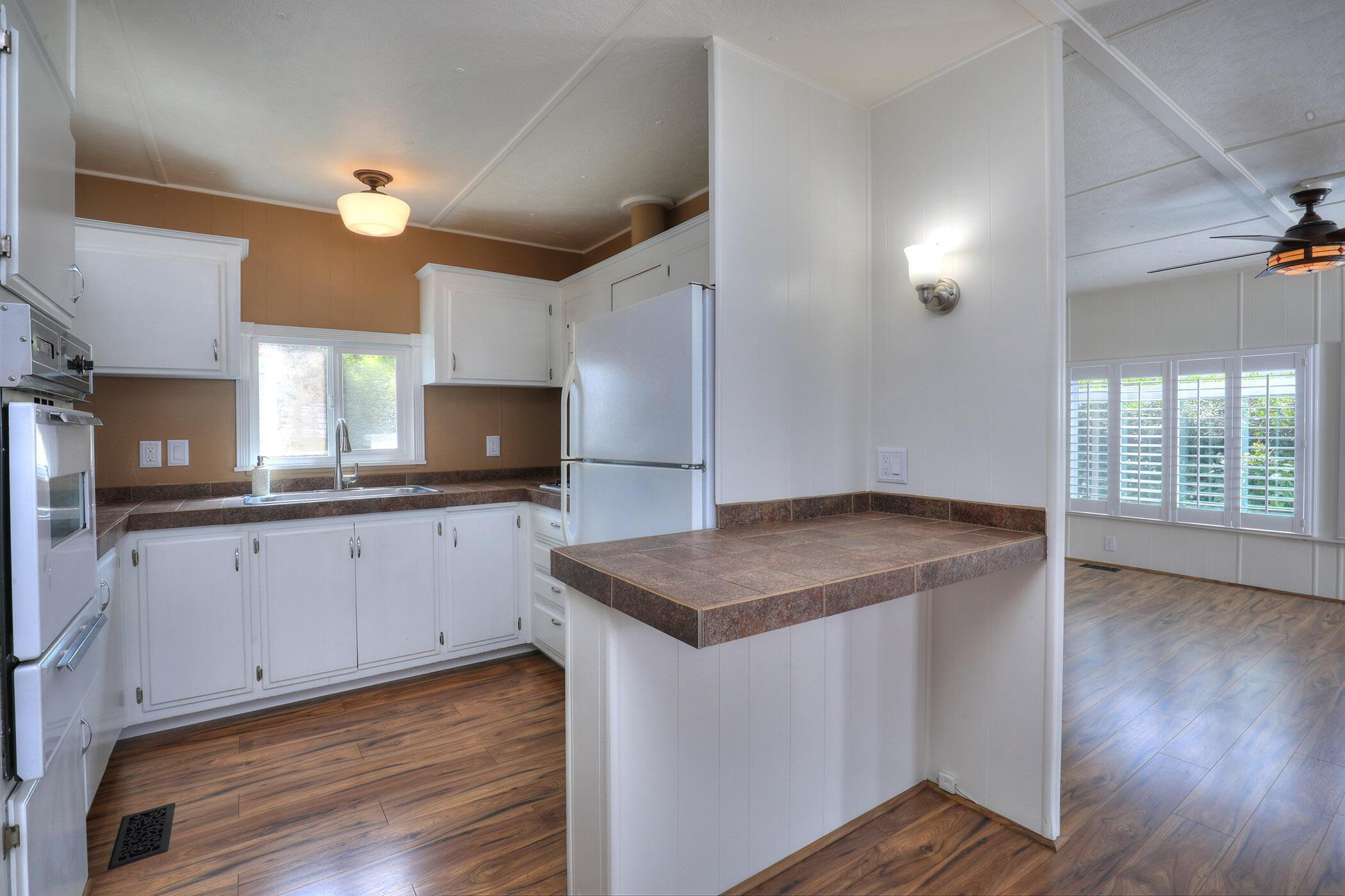30 Winchester Canyon Road, Unit SPC 50 Goleta, CA 93117 - Photo 8 of 30 a kitchen with a sink cabinets and wooden floor