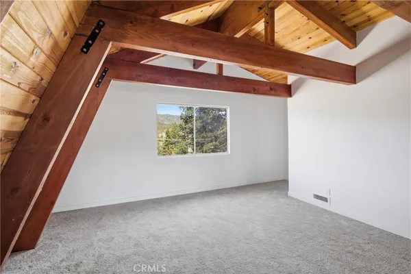 a view of a room with a bed