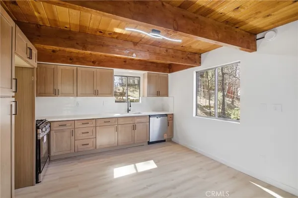 a view of a kitchen with sink dishwasher and wooden floor