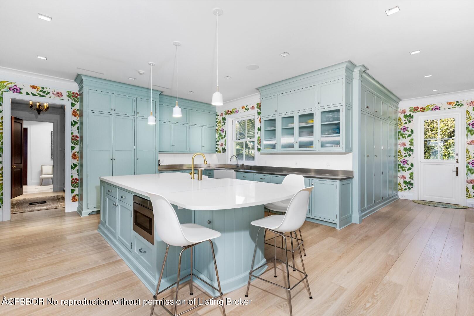 710 South County Road Palm Beach, FL 33480 - Photo 22 of 69 a kitchen with kitchen island a sink table and chairs