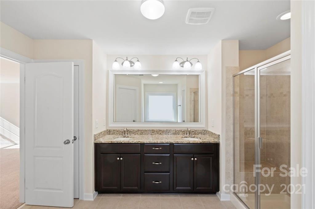 4331 Oxford Mill Road Waxhaw, NC 28173 - Photo 26 of 48 a bathroom with a granite countertop double vanity and a mirror