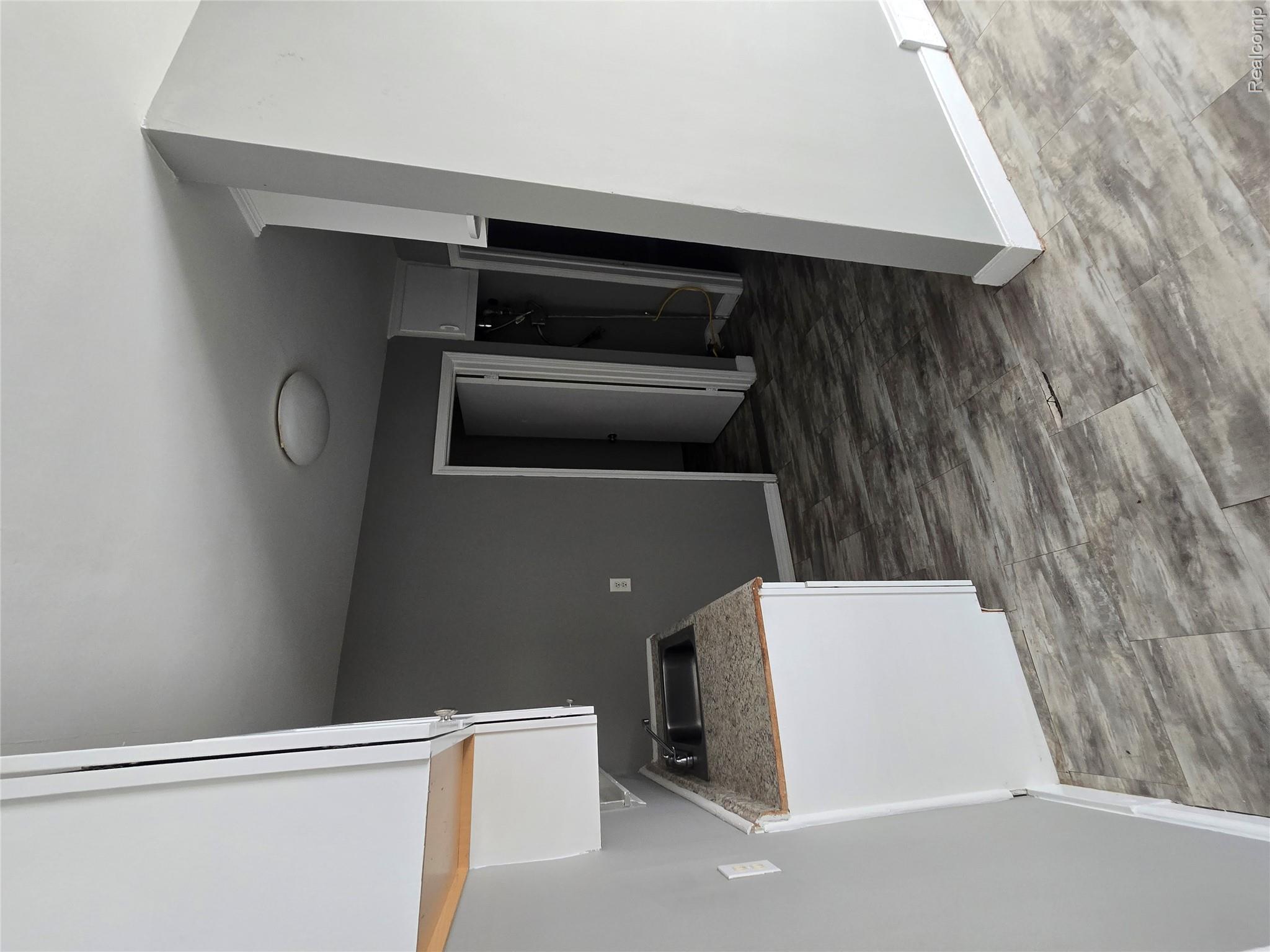 18119 Cornwall Street Detroit, MI 48224 - Photo 6 of 18 Kitchen with white cabinetry and light countertops
