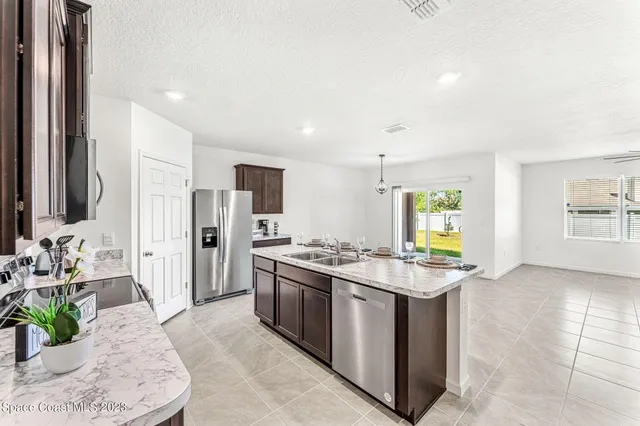 a kitchen with stainless steel appliances granite countertop a stove top oven a sink a counter top space and cabinets