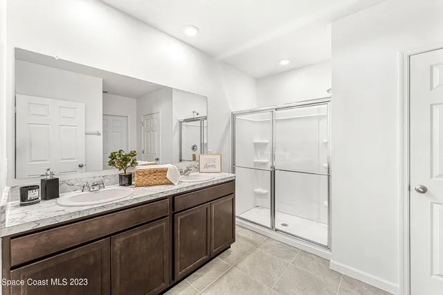 a bathroom with a sink double vanity and a mirror